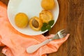 Ripe fresh apricot fruits on a white plate on the wooden background. Copy space, delisious healthy food Royalty Free Stock Photo