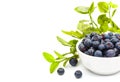 Ripe fresh blueberries in a small white ceramic bowl, isolated on white background and an empty place for your text. Close-up. Royalty Free Stock Photo