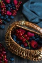 Ripe fresh blueberry, raspberry and red currant with wicker straw basket Royalty Free Stock Photo