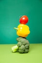 Ripe fresh colorful broccoli bell pepper and tomato against green background Royalty Free Stock Photo