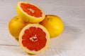 Ripe fresh grapefruits on white wooden table