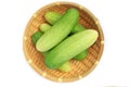 Ripe Fresh green cucumbers in basket isolated on white background. Royalty Free Stock Photo