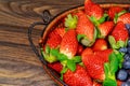 Ripe sweet strawberries in basket on wooden background Royalty Free Stock Photo