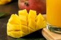 Ripe fresh mango fruit and slices and mango juice in a glass on a dark background. tropical fruit. close-up Royalty Free Stock Photo