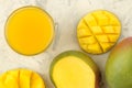 Ripe fresh mango fruit and slices and mango juice in a glass on a light background. tropical fruit. top view Royalty Free Stock Photo
