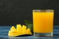 Ripe fresh mango fruit and slices and mango juice in a glass on a blue wooden table. tropical fruit Royalty Free Stock Photo