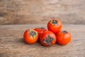 Ripe fresh persimmon on wood board. Food ingredient.