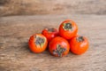 Ripe fresh persimmon on wood board. Food ingredient.