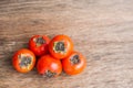 Ripe fresh persimmon on wood board. Food ingredient.