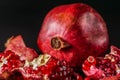 Ripe; fresh pomegranate fruit; on black background.