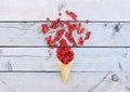 Ripe fresh red currants in ice cream waffle cone on rustic wooden background Royalty Free Stock Photo