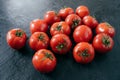 Ripe fresh red organic tomatoes being wet and clean, isolated over black background. Detailed close up shot. Selective focus Royalty Free Stock Photo