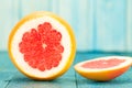 Ripe fresh sliced grapefruit on a blue wooden background. Diet, vegetarianism Royalty Free Stock Photo