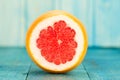 Ripe fresh sliced grapefruit on a blue wooden background. Royalty Free Stock Photo