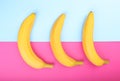 Ripe, fresh and sweet yellow bananas on a bright pink and light blue background. Tropical bananas. Banana, close-up.