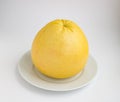 Ripe fruit pomelo on a white plate Royalty Free Stock Photo