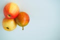 Ripe fruit. Two pears and an apple on a white background. Royalty Free Stock Photo