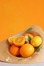 Ripe fruits in a summer hat, oranges and lemons. Citrus fruits Royalty Free Stock Photo