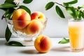 Ripe fruits of whole peaches and a glass of fruit juice on a white table. Fresh harvest