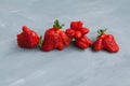 Ripe funny strawberry berries. Trendy food. Concept - Eating ugly fruits and vegetables. Grey background, copy space