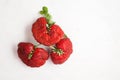 Ripe funny strawberry berries. Trendy food. Concept - Eating ugly fruits and vegetables. Top view, Copy space