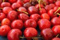 Ripe Glossy Sweet Cherries with Water Drops Scattered on Dark Background. Low Angle Shot Food Pattern