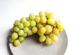 Ripe grape on grey plate close up Royalty Free Stock Photo