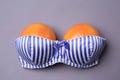 Ripe grapefruits in bra on grey background