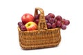 Ripe grapes and apples in the basket on a white background Royalty Free Stock Photo