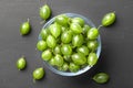 Ripe green gooseberries in a glass transparent bowl and jar on a black  background. Harvest concept agrus. Vegetarian food.Top Royalty Free Stock Photo