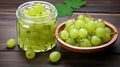 Ripe green gooseberries in a glass transparent bowl and jar on a wooden background. generative ai Royalty Free Stock Photo