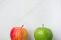Ripe Green Red Organic Apples on White Marble Background. Lower Border. Creative Minimalist Image for Culinary Vegan Website Royalty Free Stock Photo