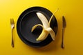 Ripe juicy banana on a black plate Royalty Free Stock Photo