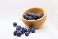 Wooden bowl of blueberries, half empty, spilled Royalty Free Stock Photo