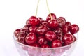 Ripe and juicy cherries in a glass bowl, red sweet cherry, organic fruit, close-up, isolated on white background Royalty Free Stock Photo