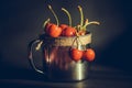 Ripe and juicy cherries in old metal cup on the dark rustic background. Selective focus. Shallow depth of field Royalty Free Stock Photo