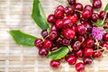 Ripe juicy cherries and wildflowers of clover in the garden in a summer day. Red cherries. Sweet summer fruits. Copy space. Macro. Royalty Free Stock Photo