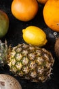 Ripe juicy fresh tropical fruits, on black dark stone table background, top view flat lay Royalty Free Stock Photo