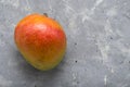 Ripe juicy fruit of the Brazilian mango from the tropics on a gray background with place for text. Exotic fresh fruits. vitamins Royalty Free Stock Photo