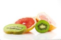 Ripe and juicy fruits of grapefruit and kiwi and their parts close-up isolated on white background. Royalty Free Stock Photo