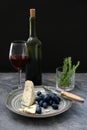 Ripe juicy grapes with cheese and red wine on grey table Royalty Free Stock Photo