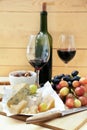 Ripe juicy grapes with cheese and red wine on wooden table Royalty Free Stock Photo