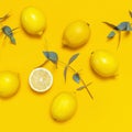 Ripe juicy lemons and green eucalyptus twigs on bright yellow background. Lemon fruit, citrus minimal concept. Creative summer Royalty Free Stock Photo