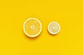 Ripe juicy lemons, orange on bright yellow background. Lemon fruit, citrus minimal concept, vitamin C. Creative summer