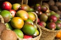 Ripe juicy mango in wicker baskets on market counter