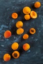 Ripe juicy orange apricots on a blue concrete background, view from above. Copy space