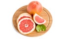 Ripe juicy orange grapefruit whole and cut with leaves on a cutting board close-up.