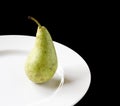 Ripe juicy pear on white plate