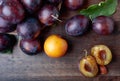 Ripe juicy plums on a wooden background. Royalty Free Stock Photo