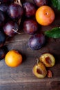 Ripe juicy plums on a wooden background. Royalty Free Stock Photo